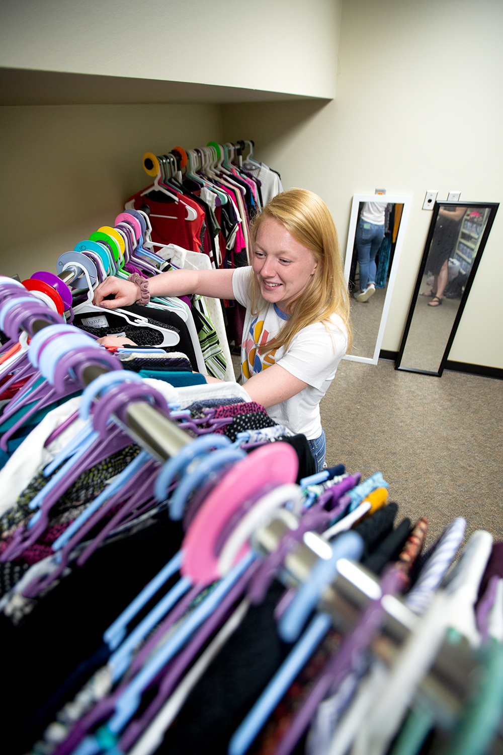 Miranda Danzeisen sorts clothes in the career closet.