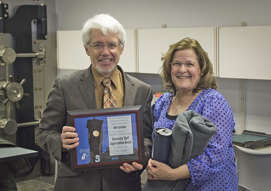 Interim Chancellor Patrick Guilfoile presents Barb Larrabee with the February University Staff Appreciation Award.