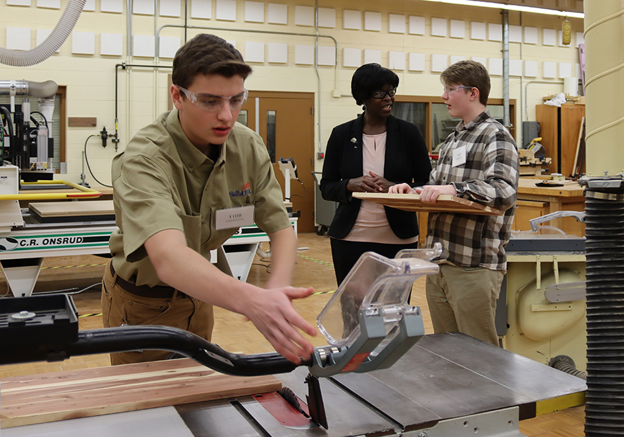 Wisconsin Secretary of Safety and Professional Services Dawn Crim, in center, talks with students during the Reginal SkillsUSA competition.