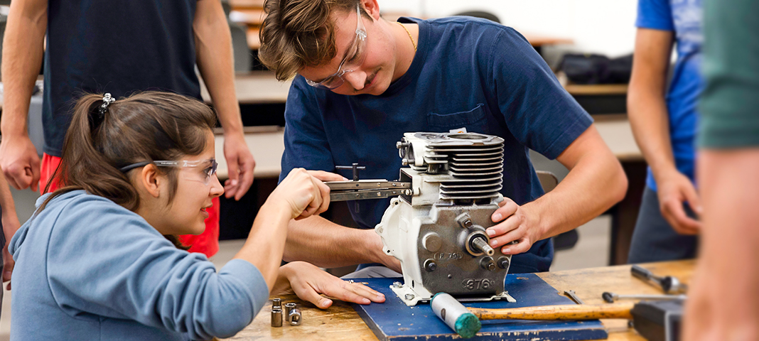 Student deconstruct an engine.