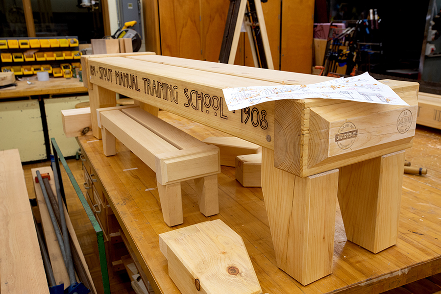 One of the two finished benches bears the name Stout Manual Training School, the university’s name when it was founded in 1891.