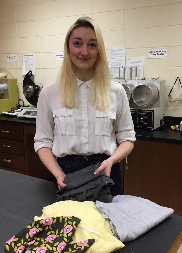 Cambria Sinclair holds hemp fabric in the lab.