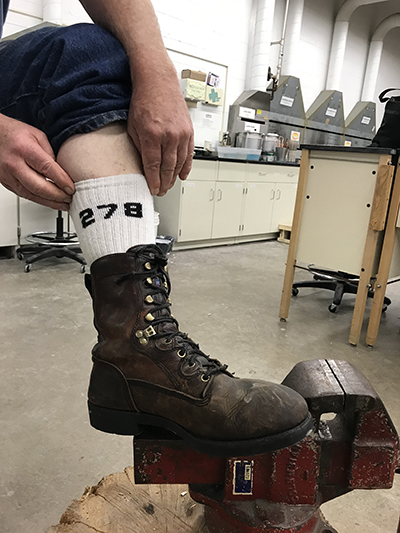 Arne Thompson, a retired veteran from northern Dunn County, wears 278th Brigade socks while working recently in a UW-Stout art lab.