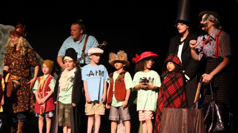 River Heights kindergarten teachers and students present “Caps for Sale” with teacher Det Bossany as Mama Monkey, UW-Stout student Chelsea Kuchinski as Abraham Lincoln and teacher Tanya Staatz as the Peddler. Recent UW-Stout graduate Beau Janke plays the banjo.