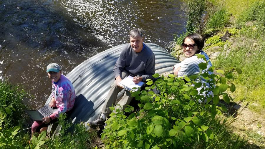 From left, intern Heidi Lieffort, CLRR Director Bill James and CLRR Manager Mai Lia Vang sample water from Horse Creek, which flows into Cedar Lake in Polk County.