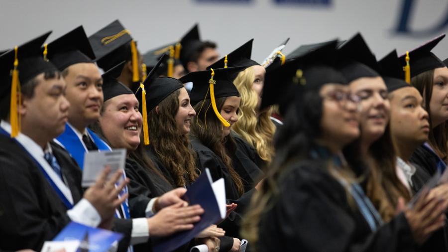 Graduates take part in a spring 2022 commencement ceremony at Johnson Fieldhouse.