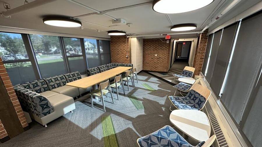 A lounge space with natural light features a study table in South Hall.