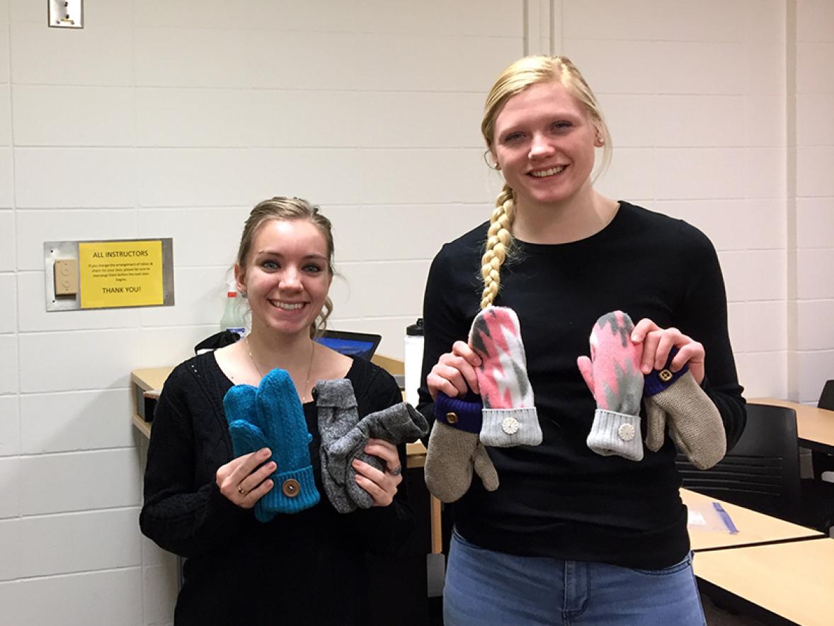 UW-Stout Phi Upsilon Omicron-Tau Chapter members Abby Marron, at left, and Stephanie Pladies show some of the mittens created by members by repurposing sweaters and fleece tops. The mittens were donated to the Wisconsin Foster Closet in Menomonie.
