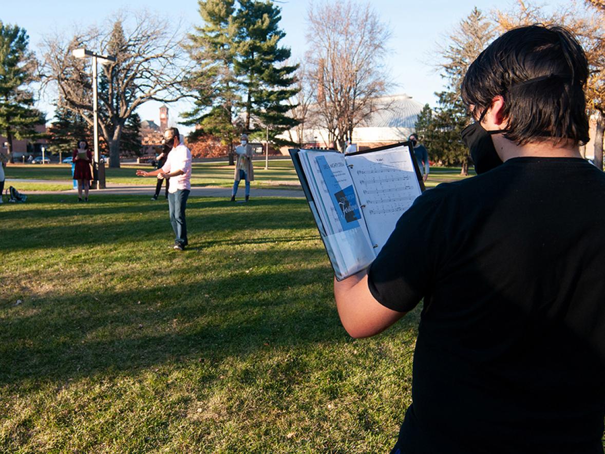UW-Stout’s Symphonic Singers practice outside on campus with social distancing to prevent the spread of COVID-19.
