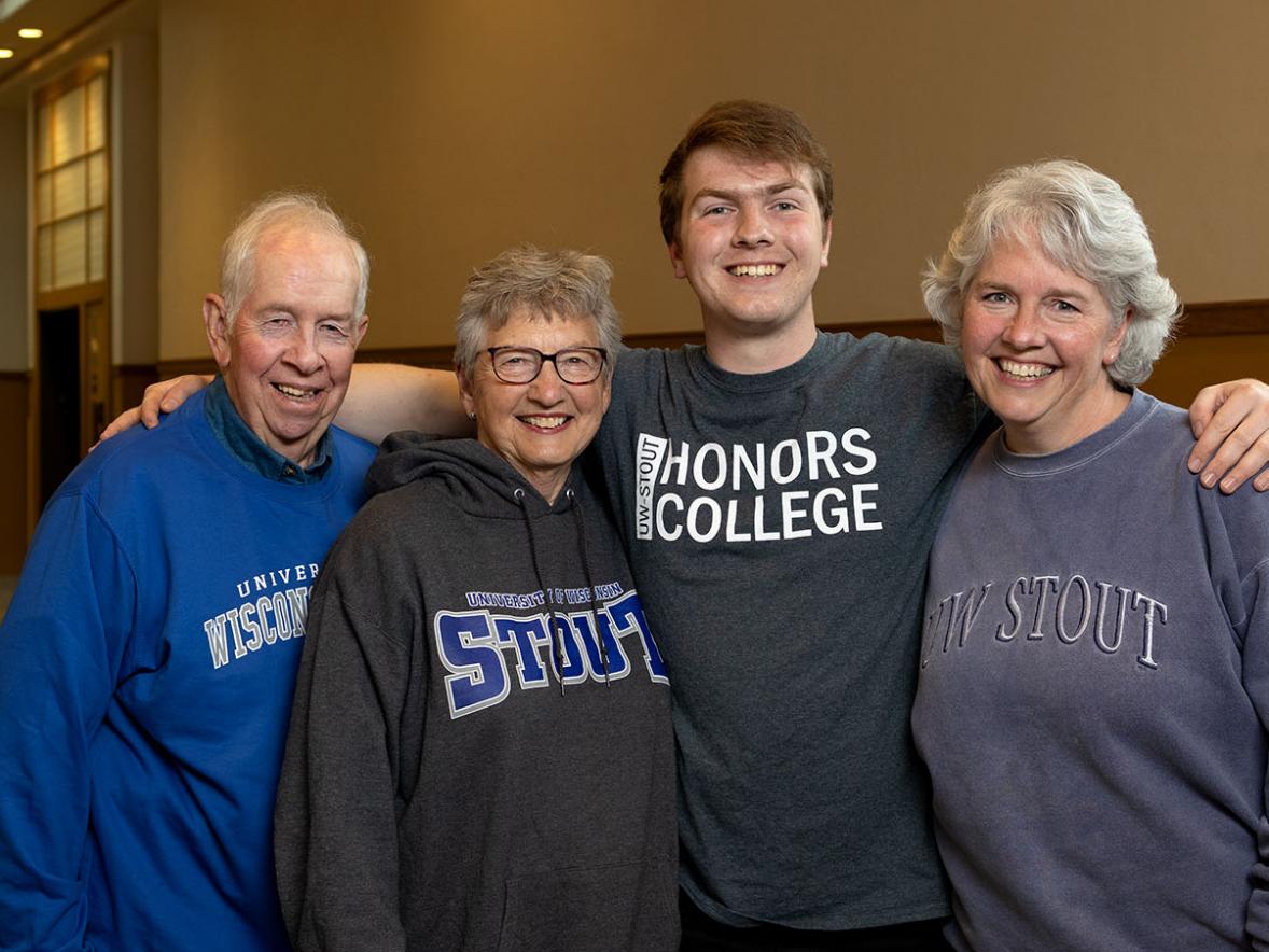 Nathan Thompson, a third-generation student, poses with his family in Harvey Hall.