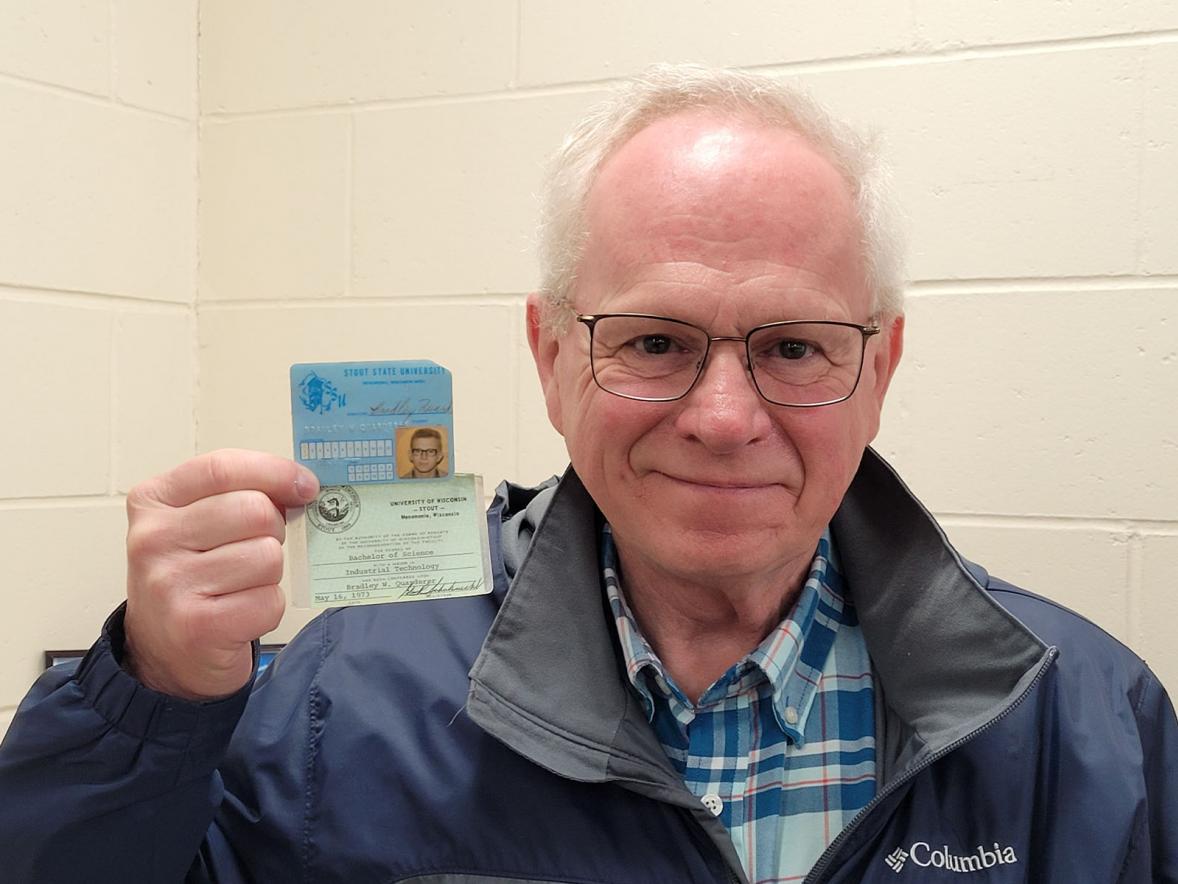 UW-Stout alum Bradley Quarderer with his student ID and graduation card.