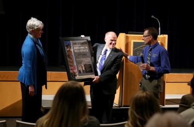 Jeff Ylinen (center) receives a plaque honoring him as an Executive in Residence from Deanna Schultz, associate professor in CTE, and Urs Haltinner, a CTE professor, Tuesday, February 13, 2018 in the Great Hall of the Memorial Student Center. 