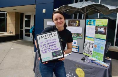 Katie Ankowicz, UW-Stout student, displays her sustainability pledge.