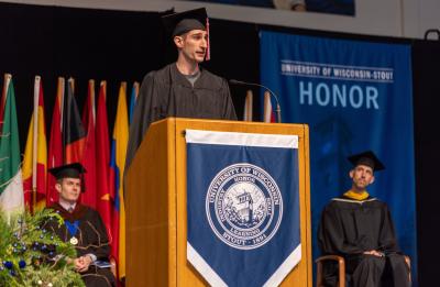 Master’s degree recipient and speaker Corey Tellier addresses fellow graduates during the Graduate School ceremony.